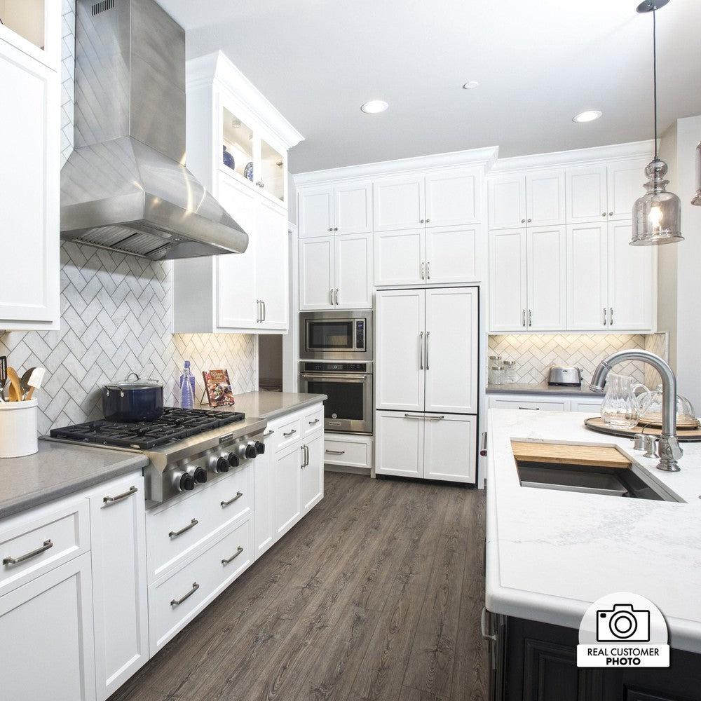 ZLINE Professional Convertible Vent Wall Mount Range Hood in Stainless Steel (587) in a modern cottage-style kitchen.